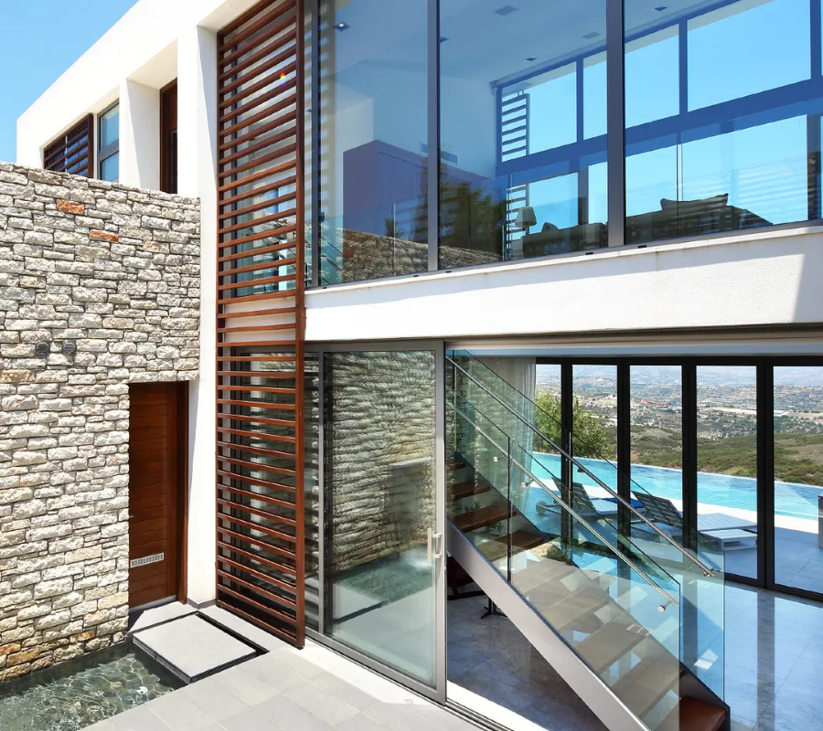 Interior living space at Minthis with a woman on the stairs